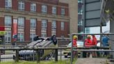 Dramatic moment car is flipped onto roof after being 'smashed into safety barrier' outside college