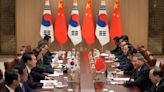 China calls on Japan and South Korea to reject 'protectionism' in trilateral summit