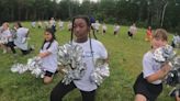 NFL cheer squad gifts pom-poms to Westbrook elementary school team