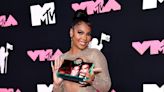 Ashanti confirms she and Nelly are back together as she holds purse with their photo at 2023 MTV VMAs
