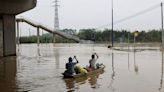 China floods: Four dead as cities submerged after days of record breaking rainfall