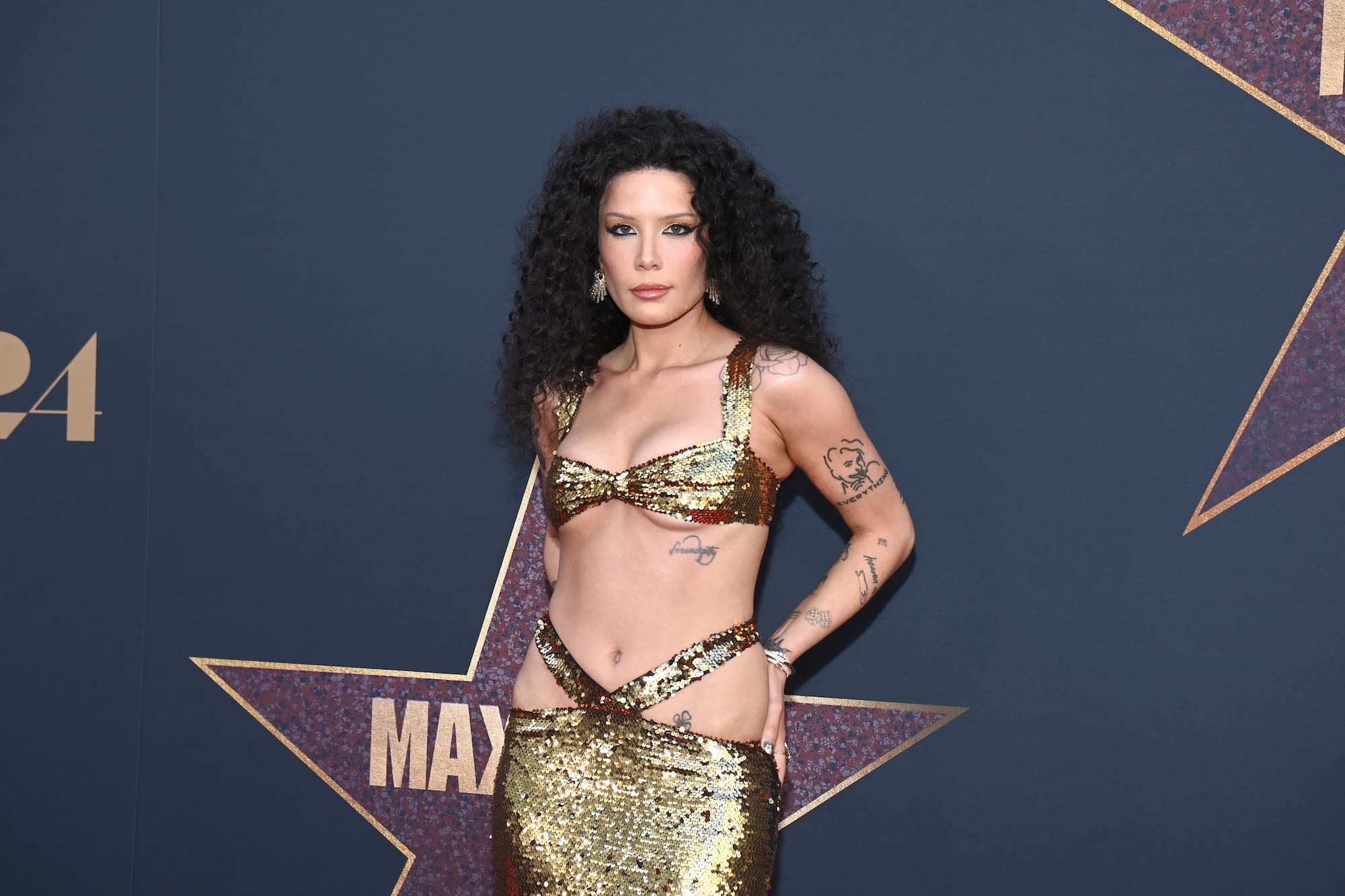 Halsey Channels Cher in Sequined Gold Gown With Hip Cutouts at ‘MaXXXine’ Premiere