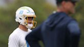 Los Angeles Chargers quarterback Justin Herbert and head coach Jim Harbaugh look on during an OTA session at Hoag Performance Center on June 4, 2024, in...