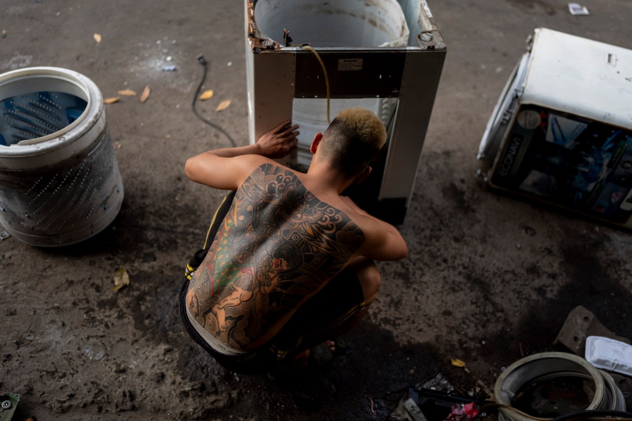 E-waste is overflowing landfills. At one sprawling Vietnam market, workers recycle some of it