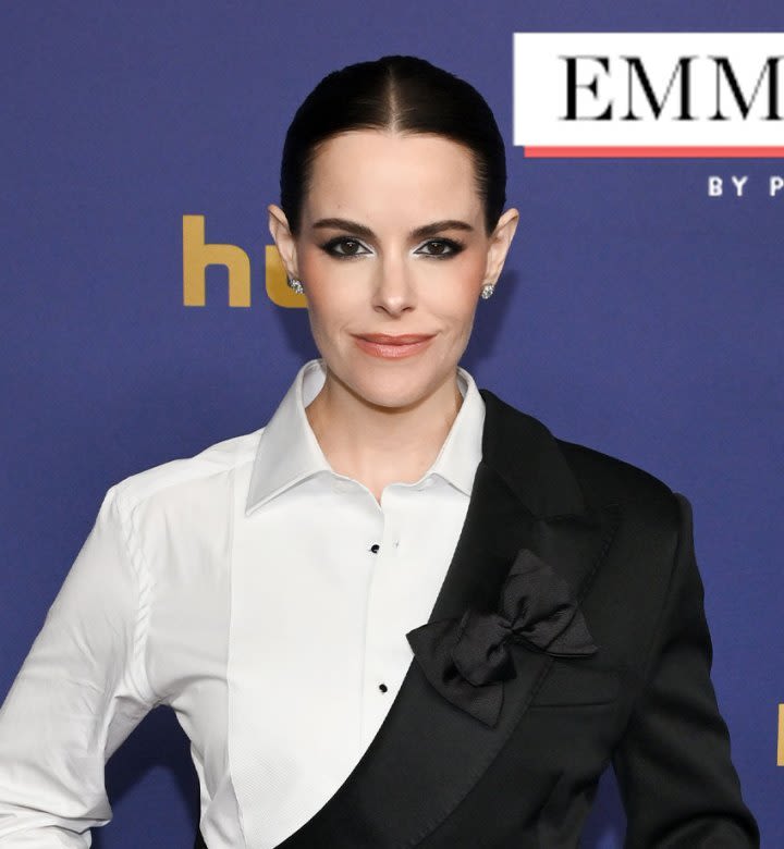 Emily Hampshire Puts a Twist on a Classic Black Tux at the Emmys (& It's Giving Major Moira Rose Vibes)