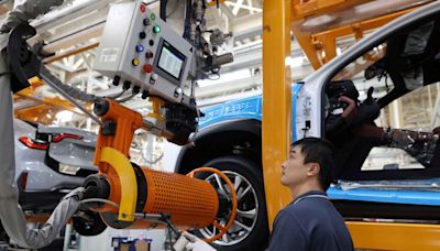 China's factory, service sectors skid, emboldening stimulus calls