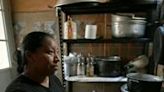 Rosalina Gomez, who works as a cleaner at Cancun airport, cooks at her home in the Mexican resort city