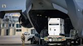 A United States serviceman stands guard on May 15, 2024, as supplies are unloaded from a U.S. Air Force C-17 cargo plane on the tarmac at Toussaint Louverture International...