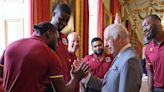 Charles learns fist-bump from players on the West Indian cricket team