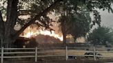 Lightning and a burning car pushed into a gully are blamed for wildfires scorching Pacific Northwest