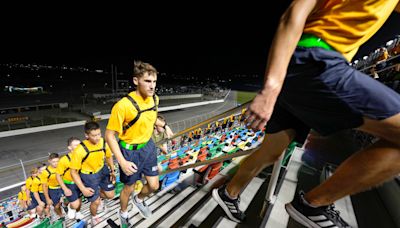 Students climb stairs at Daytona International Speedway in memory of fallen firefighters