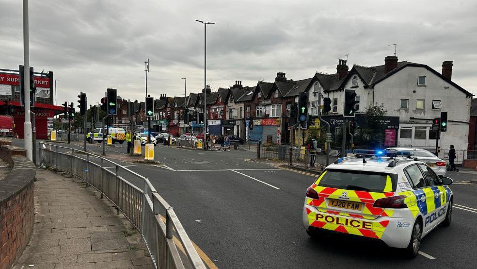 Police car flipped over amid ongoing disorder