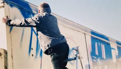 Never-before-seen photos of Banksy show him painting mural before he was famous