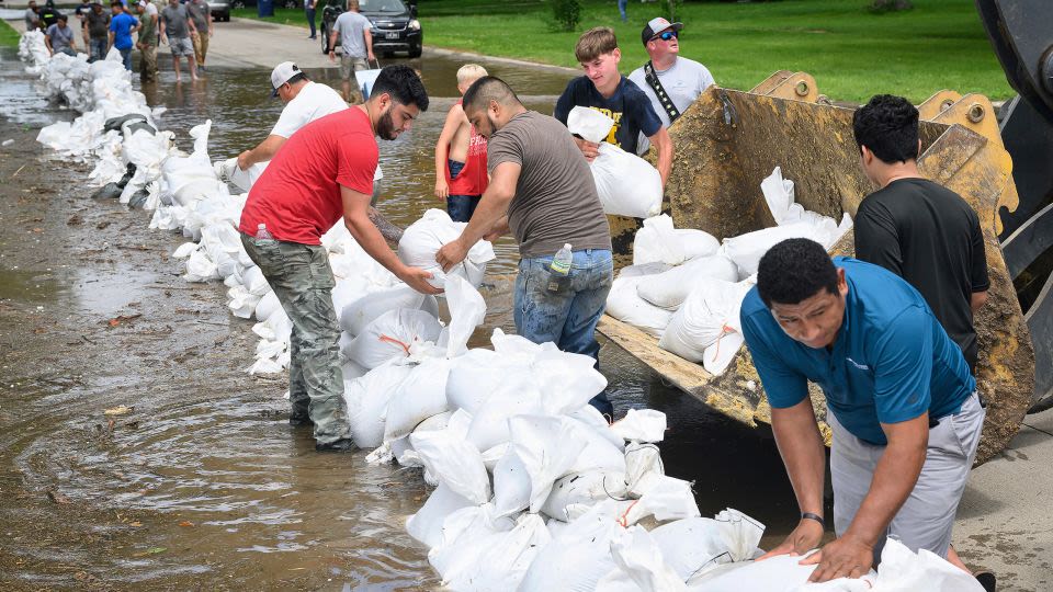 ‘Catastrophic flooding’ in Upper Midwest prompts evacuations as record-breaking heat wave broils the West and mid-Atlantic