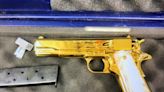 A woman was arrested after flying from LA to Sydney with a gold-plated handgun in her luggage, border police say