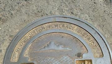 Answer Woman: Who makes the manhole covers with river, mountains and sky design? How many?