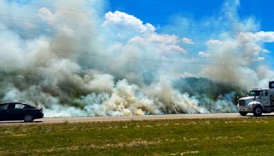 PHOTOS: 300-ft. ditch fire burns on West Andrew Johnson Highway amid dry conditions