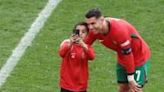 The first of several pitch invaders at Portugal's game against Turkey was successful in obtaining a selfie with Cristiano Ronaldo