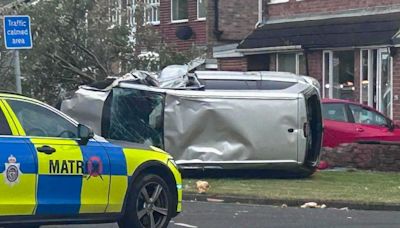 Flipped car brings down tree and comes to a stop outside home as dramatic pictures show near miss