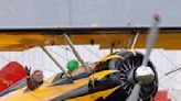 Tom Cruise hangs off the side of a plane for Mission Impossible