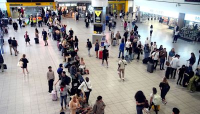 Huge queues snake though Gatwick airport as global IT outage disrupts flights