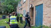 Police smash down door in raid as five arrested