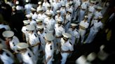 Watch: US Naval Academy freshmen attempt to climb 21ft-tall greased monument to mark end of first year
