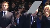 Joe Biden tries to sit on 'invisible chair' during D-Day memorial event