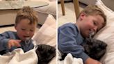 Toddler adorably tucks cat in next to him for "bedtime snuggles"