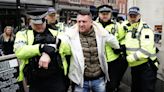 Tommy Robinson escorted from march against antisemitism as thousands gather