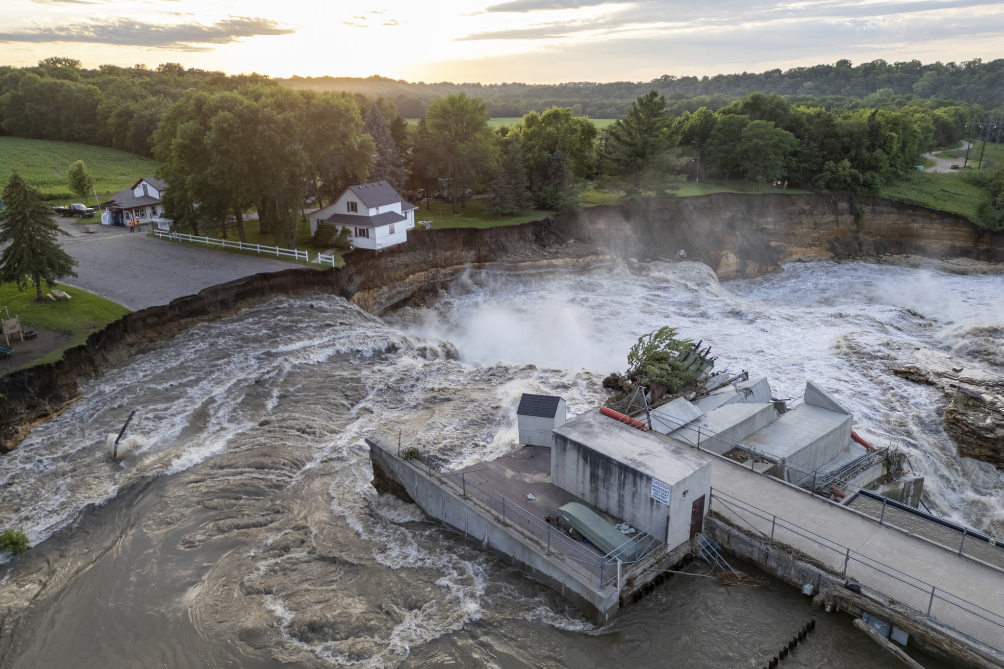 Swollen river claims house next to Minnesota dam as flooding and extreme weather grip the Midwest