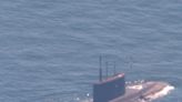 A NATO sub hunter captured these shots of a Russian submarine in waters newly surrounded by the alliance