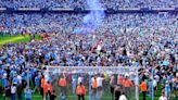 Manchester City players and fans celebrate step one of the treble