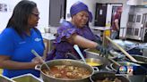 African woman cooking up home cooked meals from her native country