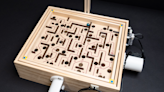 Watch an AI robot learn how to demolish humans at a marble maze game