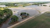 Rail bridge collapses during Midwest flooding as a heat wave persists across much of the US