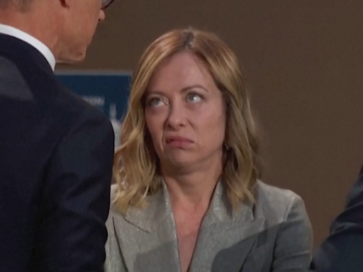 Italian prime minister looks at imaginary wristwatch while waiting for Biden at Nato summit