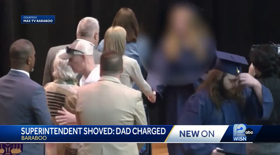 Dad pushes superintendent away from graduating daughter, video shows. He’s charged