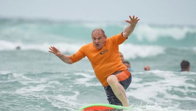 Sir Ed Davey braves the choppy surf to highlight water pollution