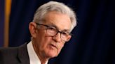 Fed holds key interest rate and warns on inflation