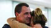 Chris Salmon embraces his wife Marney after arriving in Brisbane from New Caledonia on May 21, 2024