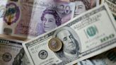 Pound hits two-year low against dollar after UK economy contracts