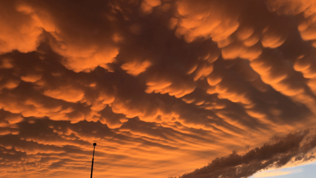 Enigmatic mammatus clouds lend an eerie beauty to post-storm landscape