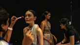 AP PHOTOS: Behind the runway glamour, a fashion army at work