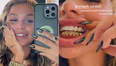 'Grillz': namorada de Oruam adere à moda de joias nos dentes e mostra boca brilhante