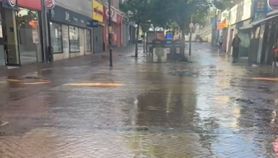 Town centre street flooded after water main bursts