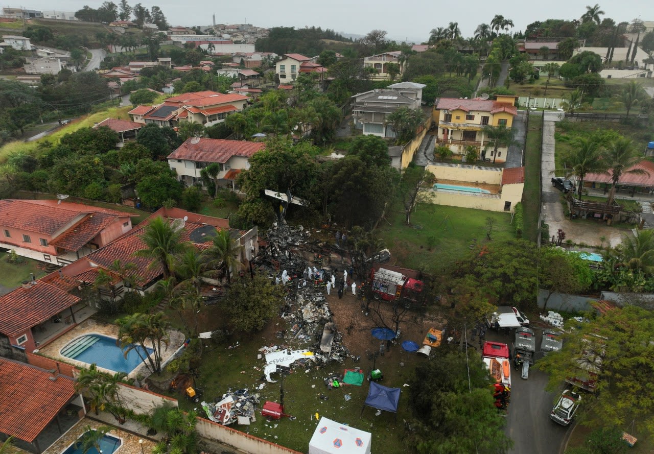 Families of Brazilian plane crash victims gather in Sao Paulo as experts work to identify the dead