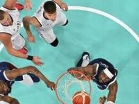 Kevin Durant (left) and Bam Adebayo (right) go for a rebound in the USA's opening Olympic victory over Serbia