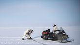 Navy SEALs on snowmobiles raced across the frozen Arctic to link up with an attack sub that broke the ice during a special-ops first