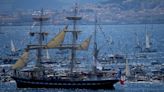 A ship carrying the Olympic torch arrives in Marseille amid fanfare and high security